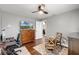 Bedroom area featuring a ceiling fan, wood floors, a desk, and a table with chairs at 14377 Lord Barclay Dr, Orlando, FL 32837
