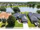 Beautiful single Gathering home with a well-manicured lawn and mature trees overlooking a serene lake at 14377 Lord Barclay Dr, Orlando, FL 32837