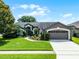 Charming single-Gathering home with a well-maintained lawn, mature trees, and inviting curb appeal at 14377 Lord Barclay Dr, Orlando, FL 32837