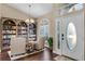 Foyer featuring a bookcase, hardwood floors, and lots of natural light at 14377 Lord Barclay Dr, Orlando, FL 32837
