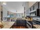 Open kitchen featuring granite countertops, stainless steel appliances, and a breakfast bar that overlooks the living area at 14377 Lord Barclay Dr, Orlando, FL 32837