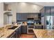 A well-equipped kitchen features stainless steel appliances, granite countertops, and dark cabinetry with ample storage space at 14377 Lord Barclay Dr, Orlando, FL 32837