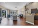 Comfortable living room with hardwood floors, a view of the pool, and access to the kitchen and dining areas at 14377 Lord Barclay Dr, Orlando, FL 32837