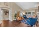 Open-concept living room with hardwood floors, neutral tones, and a view of the front door at 14377 Lord Barclay Dr, Orlando, FL 32837