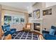 Bright living room with a stone fireplace, large windows, and comfortable seating at 14377 Lord Barclay Dr, Orlando, FL 32837