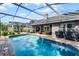 This screened-in backyard pool has an attached brick patio, ceiling fan, and barbeque, creating the perfect outdoor entertaining space at 14377 Lord Barclay Dr, Orlando, FL 32837