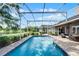 This backyard pool is surrounded by a screen enclosure, a brick patio, and lush landscaping for the ultimate outdoor experience at 14377 Lord Barclay Dr, Orlando, FL 32837