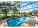 Inviting screened-in pool with a scenic view of the lake and backyard at 14377 Lord Barclay Dr, Orlando, FL 32837