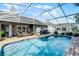 This lovely screened-in backyard pool with a brick patio, ceiling fan, and barbeque is perfect for outdoor entertaining and relaxation at 14377 Lord Barclay Dr, Orlando, FL 32837