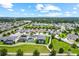 An aerial showcases the neighborhood's lush landscaping and walking paths at 14880 Ellingsworth Ln, Winter Garden, FL 34787