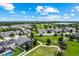 Wide aerial perspective of the neighborhood highlighting community green spaces and nearby homes at 14880 Ellingsworth Ln, Winter Garden, FL 34787