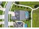 This aerial shot showcases a home with a screened pool surrounded by a landscaped backyard at 14880 Ellingsworth Ln, Winter Garden, FL 34787