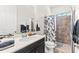 Bathroom with a shower featuring black and white floral curtain plus a vanity sink area and mirror at 14880 Ellingsworth Ln, Winter Garden, FL 34787