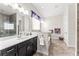 Spa-like main bathroom with dual vanities, soaking tub, separate shower, and elegant finishes at 14880 Ellingsworth Ln, Winter Garden, FL 34787