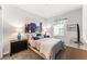 Stylish bedroom with a large painting above the bed, plus decorative lamps and modern furniture at 14880 Ellingsworth Ln, Winter Garden, FL 34787