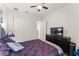 A cozy bedroom features a stylish bed, a dresser with a TV, and a ceiling fan for comfort at 14880 Ellingsworth Ln, Winter Garden, FL 34787