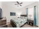 Bedroom featuring a bed with floral bedding, a ceiling fan, and two nightstands at 14880 Ellingsworth Ln, Winter Garden, FL 34787