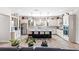 Bright kitchen features white cabinets, mosaic backsplash, stainless steel appliances, and a dark island with seating at 14880 Ellingsworth Ln, Winter Garden, FL 34787