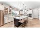 Gourmet kitchen features stainless appliances, white cabinetry, large center island with barstool seating at 14880 Ellingsworth Ln, Winter Garden, FL 34787