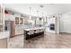 Bright kitchen features white cabinets, stainless steel appliances, mosaic backsplash, and a dark island with seating at 14880 Ellingsworth Ln, Winter Garden, FL 34787