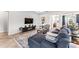 Inviting living room with a plush sectional sofa, TV, and stylish decor, perfect for relaxation at 14880 Ellingsworth Ln, Winter Garden, FL 34787