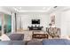Bright living room features a comfortable seating area and a modern entertainment center at 14880 Ellingsworth Ln, Winter Garden, FL 34787