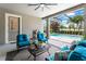 A relaxing screened patio with cozy furniture and a view of the pool and landscaped backyard at 14880 Ellingsworth Ln, Winter Garden, FL 34787