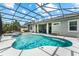 Beautiful screened pool with spa, outdoor seating, and a glimpse of the home's covered patio at 14880 Ellingsworth Ln, Winter Garden, FL 34787