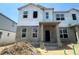 New construction home with visible framework, windows, and a concrete block base awaits its finishing touches at 15370 Burgtheater Dr, Winter Garden, FL 34787