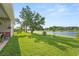 Expansive backyard overlooking a pond, providing a serene and picturesque setting with ample space for outdoor activities at 16108 Bristol Lake Cir, Orlando, FL 32828
