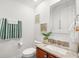 Neat half bathroom with granite vanity, decorative mirror, toilet, and a towel rack offering convenience and style at 16108 Bristol Lake Cir, Orlando, FL 32828