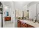 Bathroom features wooden cabinetry, double sinks, granite countertops, and modern faucets at 16108 Bristol Lake Cir, Orlando, FL 32828