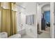 Well-lit bathroom with a shower, toilet, tiled floors, and neutral-colored towel rack at 16108 Bristol Lake Cir, Orlando, FL 32828