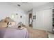 Bright bedroom features carpeted floors, a queen bed, large closet, and personal decor at 16108 Bristol Lake Cir, Orlando, FL 32828