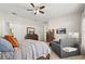 Carpeted bedroom featuring a comfortable sofa, dark wood dressers, and a wall-mounted television at 16108 Bristol Lake Cir, Orlando, FL 32828