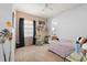 Cozy bedroom featuring a ceiling fan, large window, and decorated shelves with personal touches at 16108 Bristol Lake Cir, Orlando, FL 32828