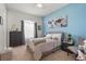 Tranquil bedroom with a queen bed, carpeted floor, side tables, and large windows at 16108 Bristol Lake Cir, Orlando, FL 32828