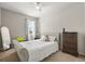 Cozy bedroom with a plush bed, ceiling fan, and natural light filtering through the window, creating a relaxing atmosphere at 16108 Bristol Lake Cir, Orlando, FL 32828