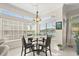Bright breakfast nook with a view, featuring large windows and a modern chandelier above a glass table at 16108 Bristol Lake Cir, Orlando, FL 32828