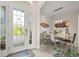 Elegant foyer featuring double glass doors, tile flooring, and a view into the dining area at 16108 Bristol Lake Cir, Orlando, FL 32828