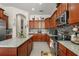 Bright kitchen featuring granite countertops, stainless steel appliances, and ample wood cabinetry at 16108 Bristol Lake Cir, Orlando, FL 32828