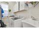 Convenient laundry room with modern washer and dryer, utility sink, and storage at 16108 Bristol Lake Cir, Orlando, FL 32828