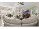 Open floor plan living room featuring large TV over mantle, large windows, and comfortable seating at 16108 Bristol Lake Cir, Orlando, FL 32828