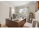 A cozy home office featuring a large desk, neutral tones, and bright natural light at 16108 Bristol Lake Cir, Orlando, FL 32828