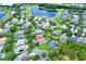Aerial view of a residential neighborhood with homes, pools, mature trees and a lake at 1657 Tennyson Ct, Lake Mary, FL 32746