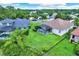 Aerial view of a home with a screened pool, surrounded by lush landscaping and mature trees at 1657 Tennyson Ct, Lake Mary, FL 32746