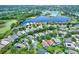 Aerial view of a large residential community with lakes, trees, and well maintained lawns at 1657 Tennyson Ct, Lake Mary, FL 32746