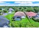 Aerial view of a home with a screened pool, lush landscaping, and mature trees at 1657 Tennyson Ct, Lake Mary, FL 32746
