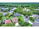Aerial view of homes in a suburban neighborhood with mature trees, circular drives and lush landscaping at 1657 Tennyson Ct, Lake Mary, FL 32746