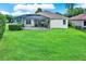 Spacious backyard with well-maintained lawn, screened-in pool area, and mature landscaping at 1657 Tennyson Ct, Lake Mary, FL 32746